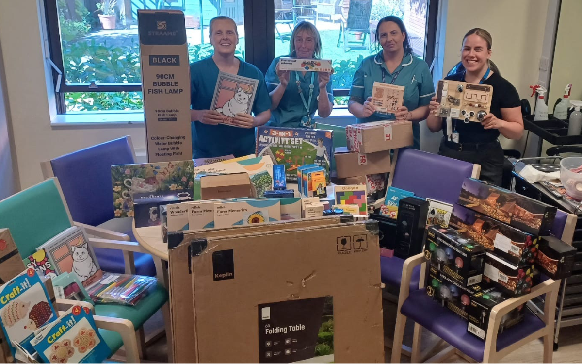 Staff on the Forget Me Not Unit at Warrington Hospital showing the items donated for local nursing home.