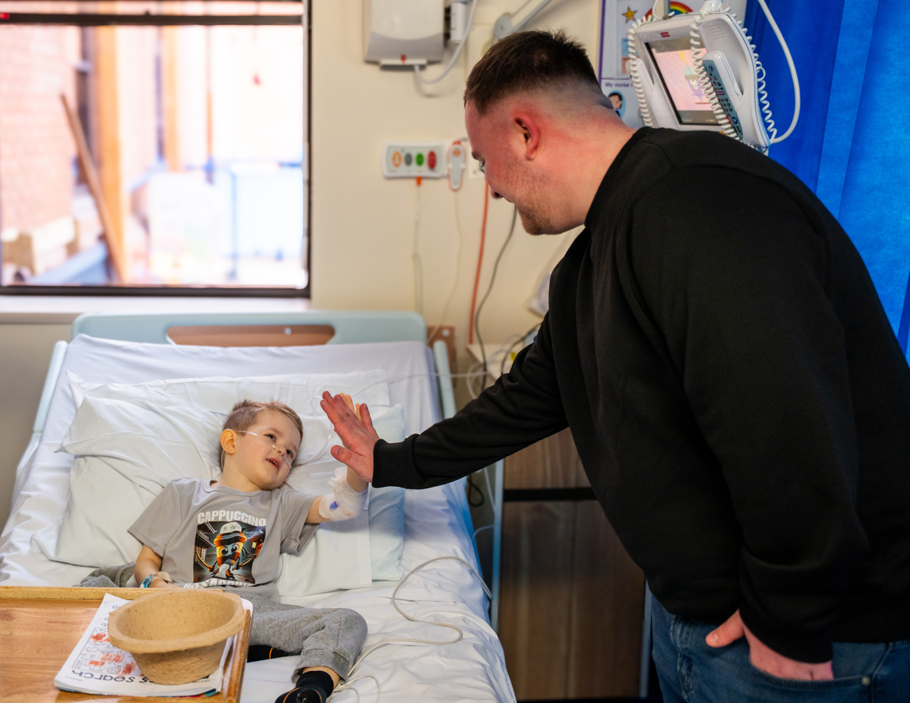 Teddy, aged 4, high-fiving Luke on the Children’s Ward 
