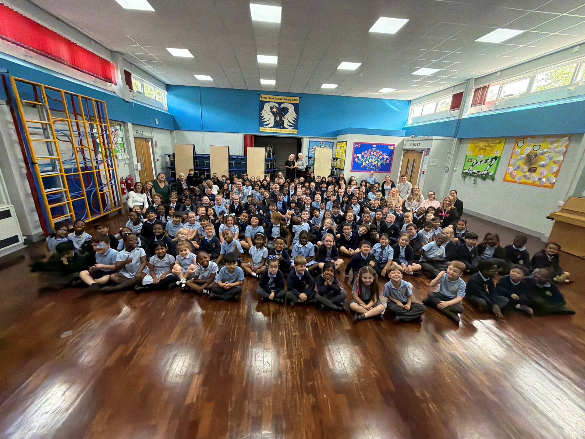 Pupils and staff at Sacred Heart Catholic Primary School being presented with award by Helen Higginson at special presentation.