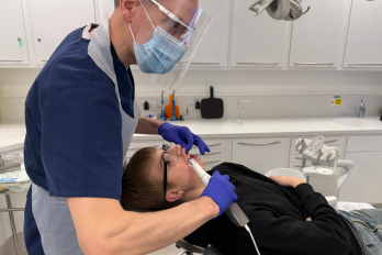 Patient Harry Underhill with consultant Ian Edwards and oral scanner.